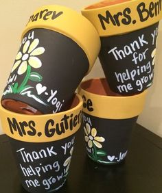 three plastic cups with writing on them sitting on a black counter top next to each other