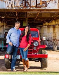 a man and woman standing in front of a red truck with the word miami on it