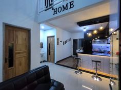 a living room filled with furniture next to a kitchen