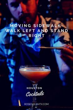 a man holding a spoon in front of a drink on a bar with the caption moving sidewalk walk left and stand right