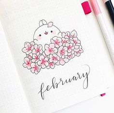 an open notebook with a drawing of a hen surrounded by flowers and the words february