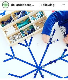 a young boy is making snowflakes out of construction paper and plastic beads