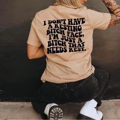 a woman sitting on the ground wearing a t - shirt that says i don't have