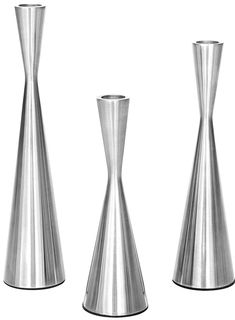 three tall silver vases sitting next to each other on a white background with no one around them