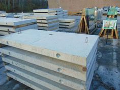 several stacks of unfinished wooden boards sitting on the ground