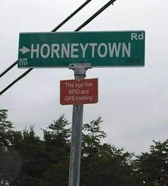 the street sign for honeytown rd is posted on a pole with power lines above it