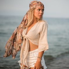 "Stay cool and fresh in this lightweight tank, crafted from breathable linen, one of our most beloved fabrics for its luxurious hand feel. The linen crop tops are designed with an adjustable wrap fit that can be adjusted from both the front and back, making it suitable for any body type. It's made of 100% natural, medium-weight linen that's been soft-washed and Oeko-Tex certified.  The linen is lightweight and breathable, making it perfect for any occasion, from formal events to casual outings with friends.  Size Bust: 39\" inches-98cm Waist: 29\" inches-73cm It is completely organic and hypoallergenic, making it perfect for those with sensitive skin. Care To care for the dress, wash it in lukewarm water at 40oC/104oF. Be careful not to use high temperatures, as this may cause shrinkage of Linen Beachwear Tops For Summer, Linen Tops For Summer Beachwear, Beige Ramie Top For Summer, Beige Ramie Summer Top, Summer Beige Ramie Tops, Spring Bohemian Linen Blouse, Bohemian Beige Linen Top, Linen Beachwear Tops For Vacation, Breezy Linen Tops For Summer