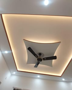 a ceiling fan is mounted to the ceiling in a room with white walls and recessed lighting