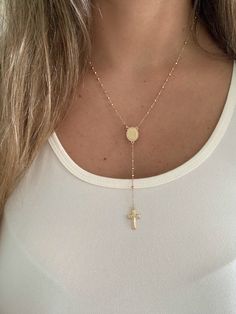 "This 14K yellow gold rosary necklace is the perfect religious symbol of faith. Featuring a cross pendant, shiny diamond cut 2.5mm round beads, and a 20\" chain, this necklace is a meaningful piece of Catholic jewelry. Its delicate design makes it an ideal gift for anniversaries, confirmations, 1st communion and other special occasions. ♦ Materials: 14K Solid Gold ♦ Available colors: Gold  ♦ Necklace measurements: 20\" total length, beads are 2.5MM ♦ Beads measurements: Beads are 2.5MM and diamo Gold Crucifix Rosary For Jewelry Making, Yellow Gold Crucifix Necklace Spiritual, Yellow Gold Crucifix With Miraculous Medal, Spiritual Yellow Gold Crucifix Necklace, Spiritual Cross Pendant For First Communion, Yellow Gold Cross Pendant Jewelry With Miraculous Medal, Yellow Gold Jewelry With Miraculous Medal Cross Pendant, Spiritual Cross Pendant Jewelry For First Communion, Gold Cross Lariat Necklace As Gift