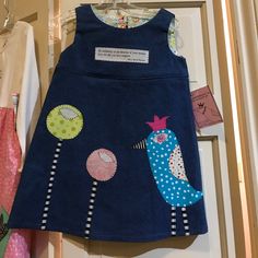 Handmade, Fully-Lined, 100% Cotton, Denim Jumper Dress With Funky Appliques Of A Bird And Flowers. Looks Cute Alone Or Over A Little Tee And Leggings. Back Of Neck To Bottom Of Skirt 19.5" Blue Cotton Patchwork Dress, Cute Blue Cotton Dress, Blue Cotton Playwear Dress, Blue Cotton Dress For Playwear, Fitted Fun Blue Dress, Fun Fitted Blue Dress, Cotton Patchwork Playtime Dresses, Playful Blue Dress For Playtime, Playful Blue Dresses For Playtime