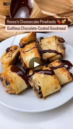 a white plate topped with chocolate covered croissants on top of a table