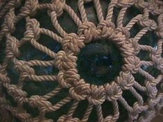 a close up view of the center part of a doily that is made out of rope