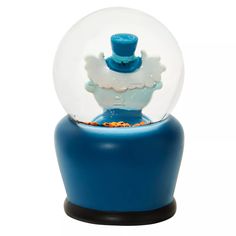 a snow globe sitting on top of a blue stand