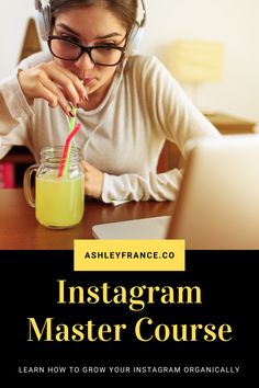 a woman with headphones on drinking from a mason jar while looking at her laptop