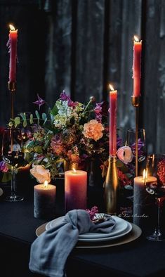 the table is set with candles and flowers