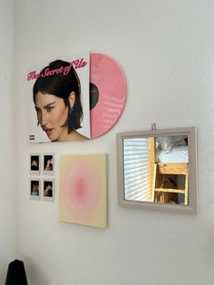 there are three pictures on the wall and one has a woman's face in it