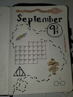 an open notebook with harry potter themed items on it and the words november written in cursive writing