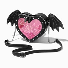 You'll be the hit of every Halloween event when you stroll in carrying this heart-shaped crossbody bag! It's just the right size for the little essentials you'll need, like your keys, cash, cards, and makeup for touchups. You'll love this stylish faux-leather bag so much that you'll probably continue carrying it all year long. The half-chain crossbody strap is adjustable for comfort, and it also detaches if you'd rather use this as a clutch bag instead. Adjustable/detachable crossbody strap6W x Gothic Bags Backpacks, Bat Wing Accessories, Pink Goth Accessories, Bat Accessory, Bats Drawing, Weird Bags, Draculaura Halloween, Pearl Market, Strange Decor