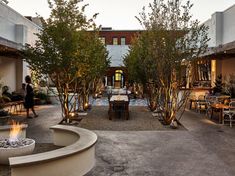 an outdoor dining area with fire pit and seating