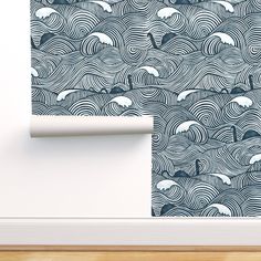 the wallpaper in this room is designed to look like an ocean wave with dolphins on it