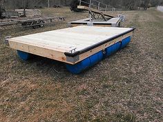 a large wooden platform sitting in the middle of a field with other equipment around it