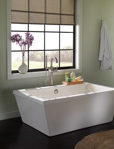 a white bath tub sitting next to a window