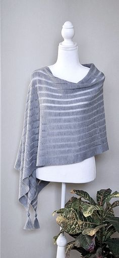 This nice grey colour merino wool poncho is very elegant and is suited to complement different outfits, it is also suitable for weddings or other formal events in your life. It's the simplest way to add some colour and freshness to your wardrobe and stylize your everyday garments. A great gift for a loved one.    Knitted 100% merino wool ponchos. The poncho is available in one size. ❤️ Several wearing variants: as poncho, scarf, headgear, beach tunic, scarf, cape, vest and etc. ❤️ Handmade with love for you Gift wrapping available.  Hand washed in lukewarm water with delicate detergent, better flat to dry.  Please note that the colours might be a little different on your computer screen. Elegant One-size Poncho For Layering, Elegant One Size Poncho For Layering, Elegant Gray Shawl For Winter, One-size Gray Poncho For Layering, Scarf Cape, Grey Shawl, Poncho Scarf, Boho Caftan, Beach Tunic