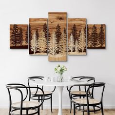 a dining room table with four chairs and a wall hanging art piece on the wall