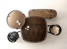 an overhead view of a wooden table with metal plates and glasses on it, along with other items