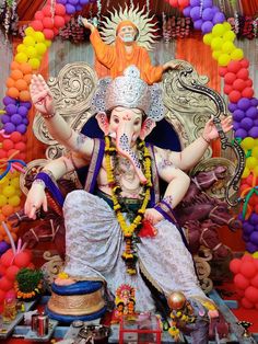 the statue of lord ganesh is surrounded by balloons