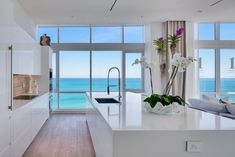 a kitchen with an ocean view is shown