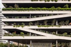 an apartment building with plants growing on the balconies