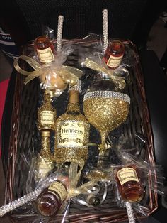 a basket filled with bottles of wine and liquor