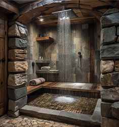 a bathroom with stone walls and flooring is shown in this image, it has a large shower