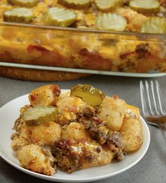 a white plate topped with food next to a casserole dish