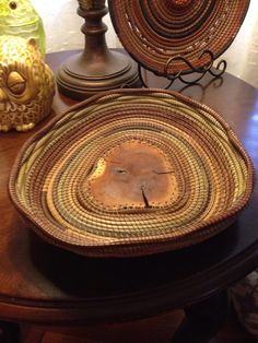 two wicker baskets sitting on top of a wooden table next to other decorative items