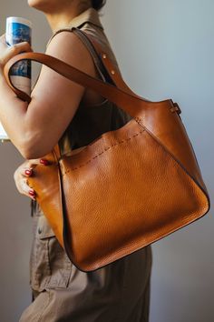 This handmade leather bag is made with 100% natural full grain leather which is tanned with all natural materials. There is no chemical materials in this leather. This bag is handmade in our studio in Milan. The lining is 100% cotton and it is easy to clean. The bag has one middle divider which is a big zipped pocket. There is One smaller zipped pocket and one small open pocket. All the bags will come with a cotton dust bag which can protect the leather and bag when it is not in use. In options Luxury Leather Hobo Bag In Natural Color, Leather Hobo Bag With Smooth Grain, Leather Hobo Bag With Smooth Grain Satchel, Leather Satchel Hobo Bag With Smooth Grain, Chic Leather Bucket Bag With Leather Backing, Daily Use Shoulder Bag In Textured Vegetable Tanned Leather, Cognac Soft Leather Hobo Bag, Daily Use Textured Vegetable Tanned Leather Shoulder Bag, Vegetable Tanned Leather Satchel With Smooth Grain