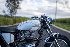 a white and black motorcycle parked on the side of the road