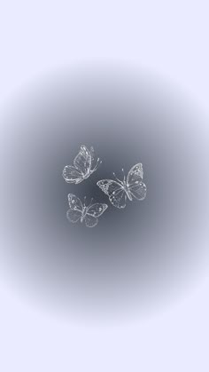 three butterflies flying in the air on a gray background