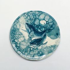 a blue and white plate with two fish on it