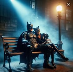 batman and catwoman sitting on a bench in the dark knight movie, with fog coming from behind them