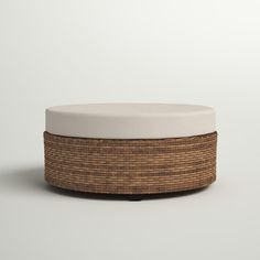 a white and brown ottoman sitting on top of a floor