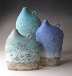 two blue vases sitting next to each other on a table