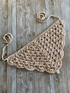 a crocheted purse sitting on top of a wooden floor