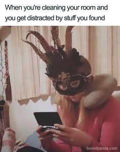 a woman wearing a masquerade while looking at her cell phone and texting