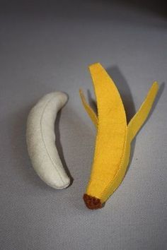 a banana sitting on top of a table next to a piece of cloth covered in felt