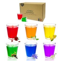 six cups filled with different colored liquids in front of a cardboard box on a white background