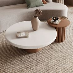 a white coffee table sitting on top of a carpeted floor next to a couch