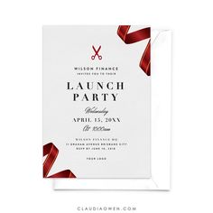 a white card with red ribbon and scissors on it, says launch party in the background