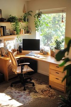 a desk with a computer and chair in front of a window filled with potted plants